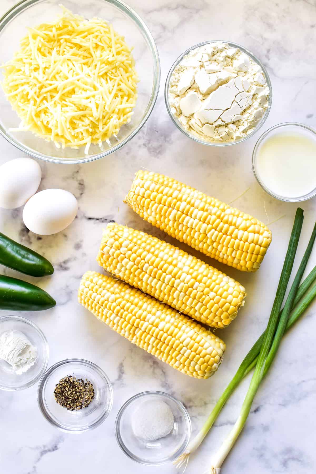 Corn Fritter ingredients on a marble background