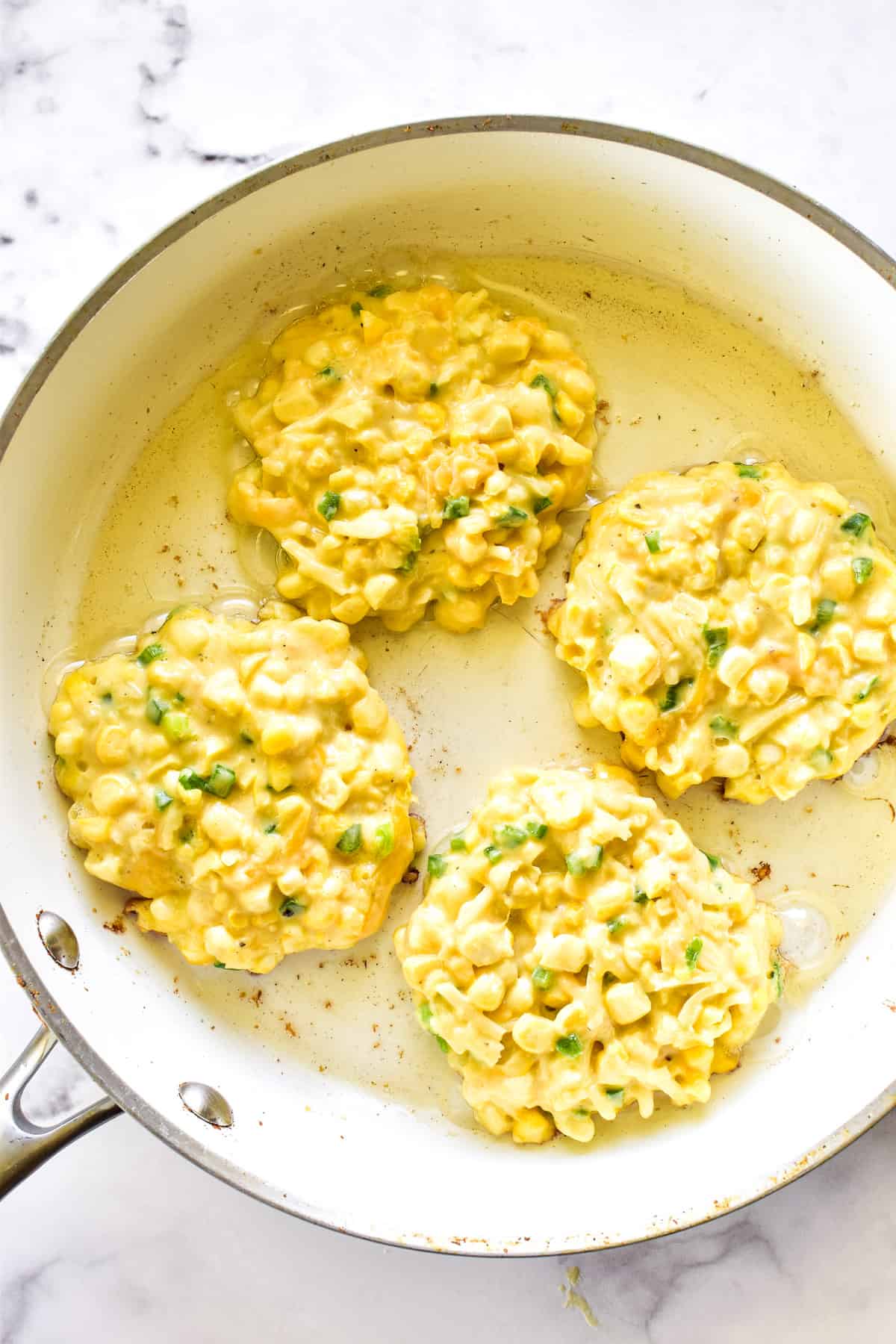 Corn Fritters in a frying pan with oil