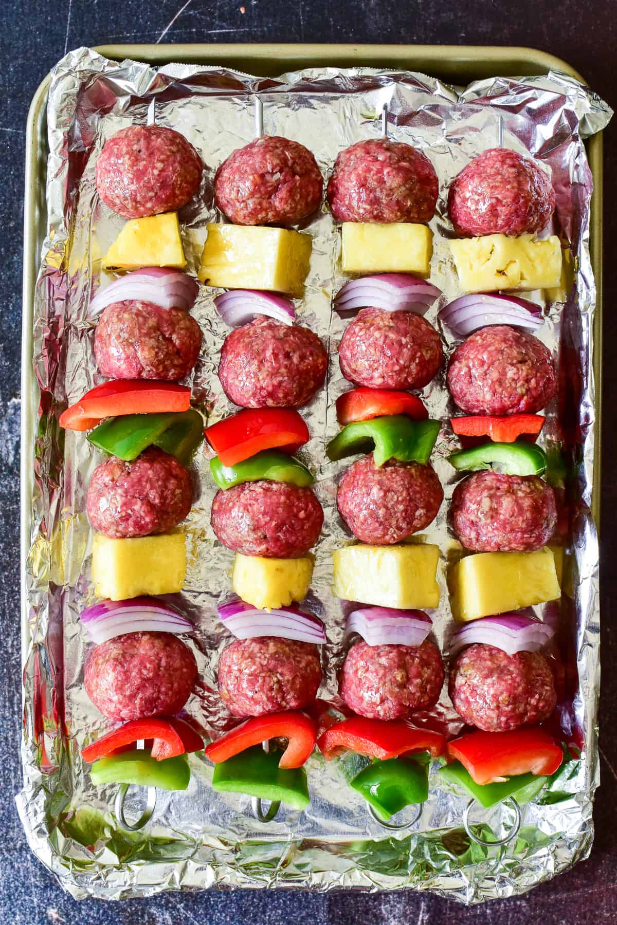 Overhead shot of Hawaiian Meatball Kabobs ready for the grill