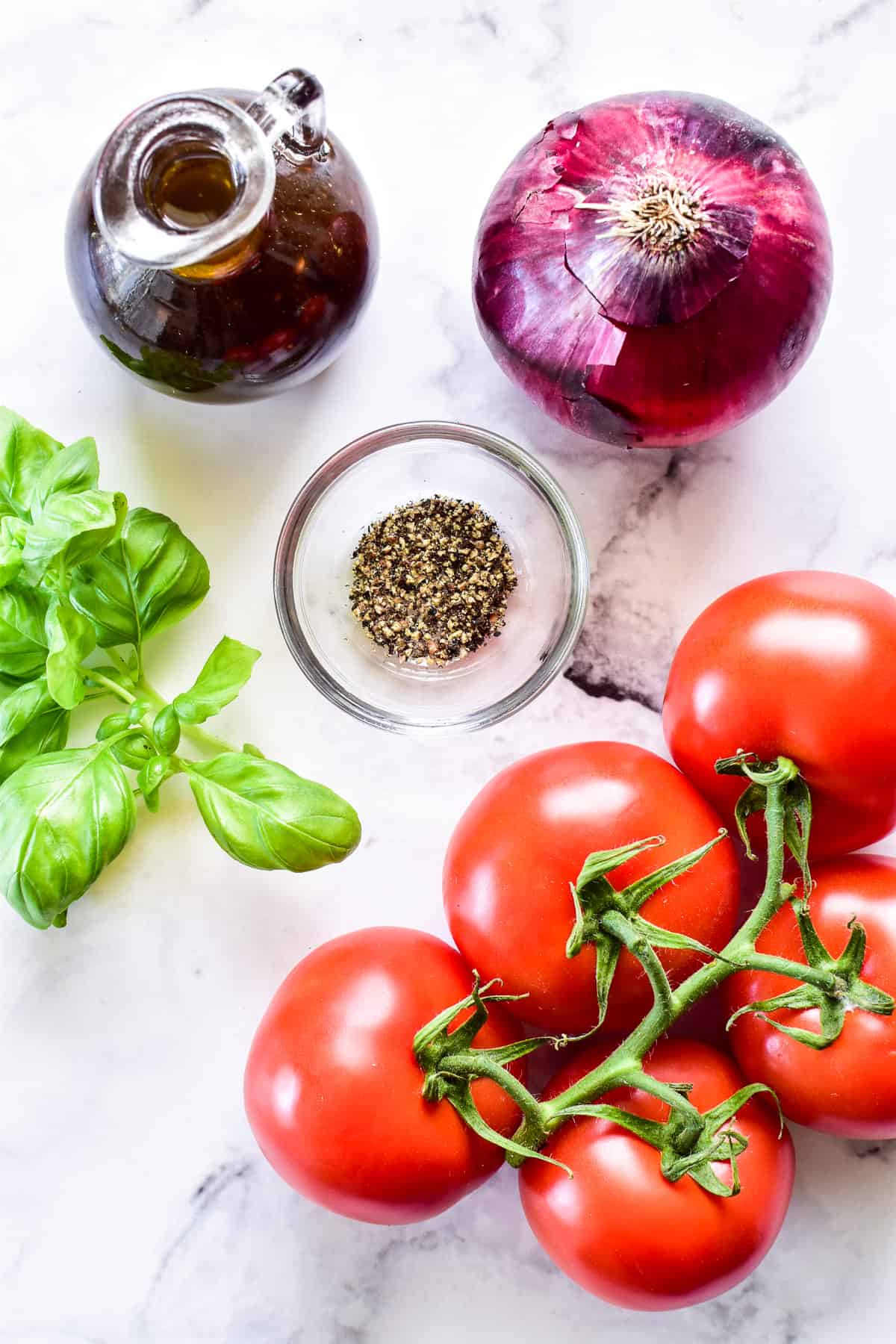 Tomato Salad ingredients on a marble board