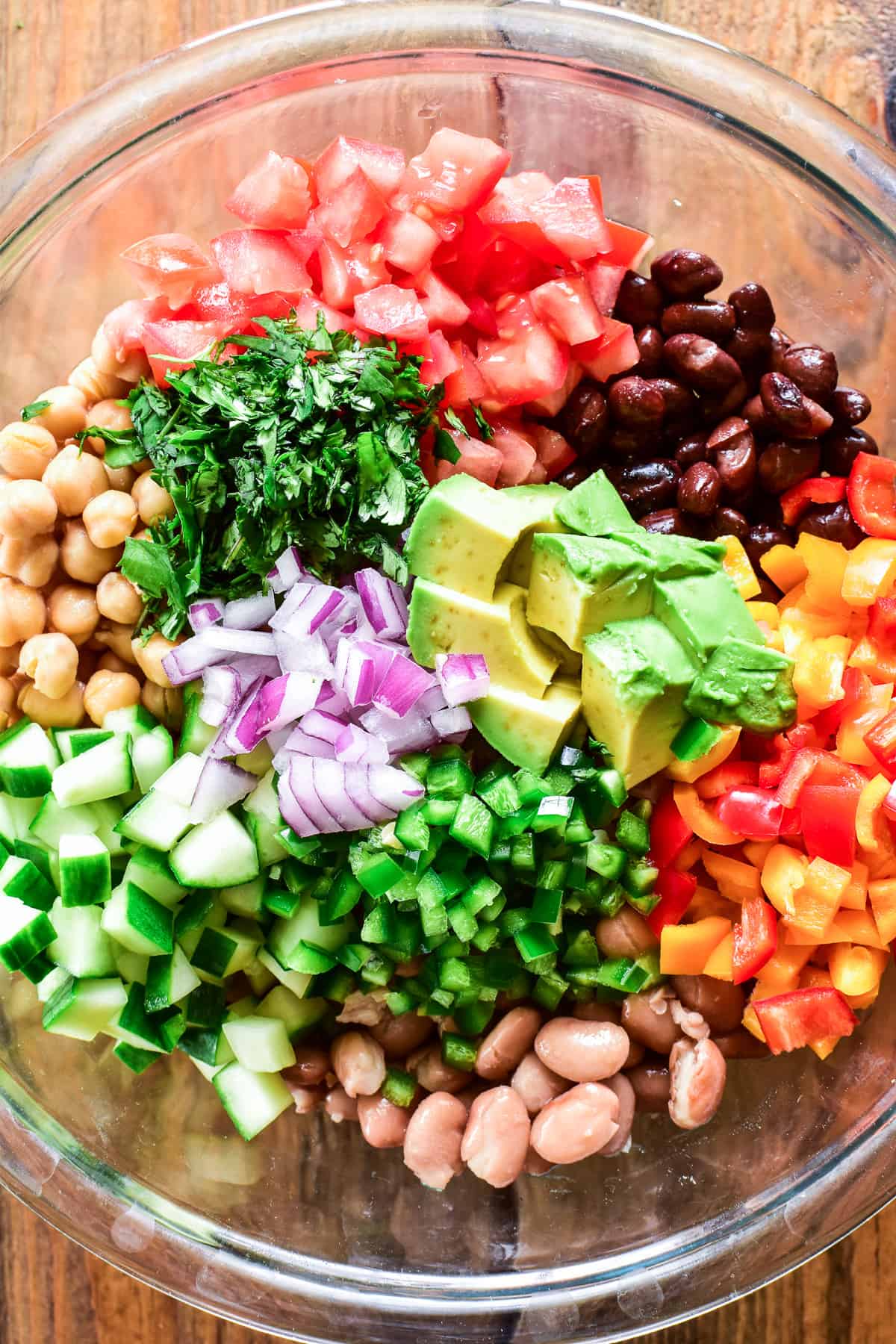 3 Bean Salad ingredients chopped in a glass mixing bowl