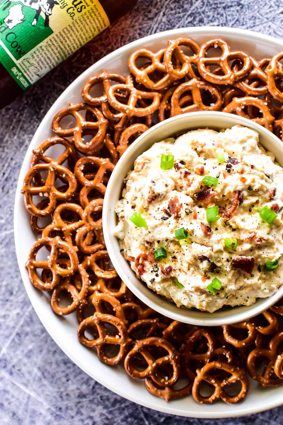 Overhead shot of Beer Cheese Dip in a bowl with pretzels