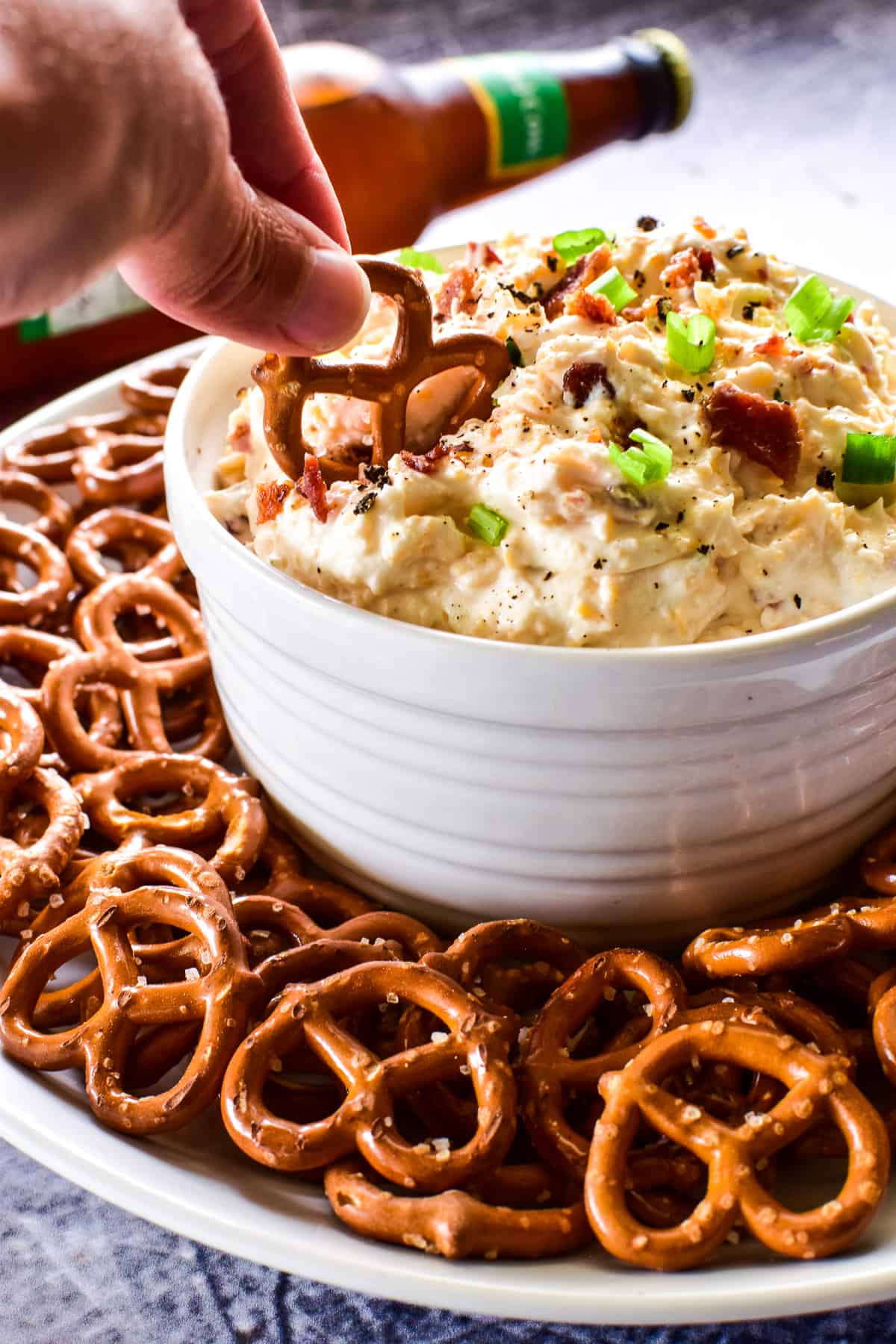 Pretzel dipping into Beer Cheese Dip