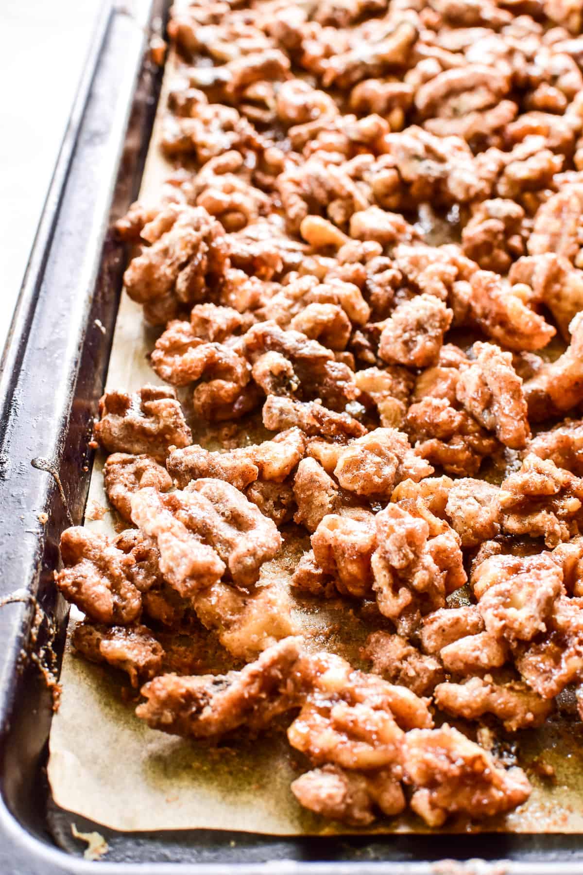 Candied Walnuts on a baking pan with parchment paper