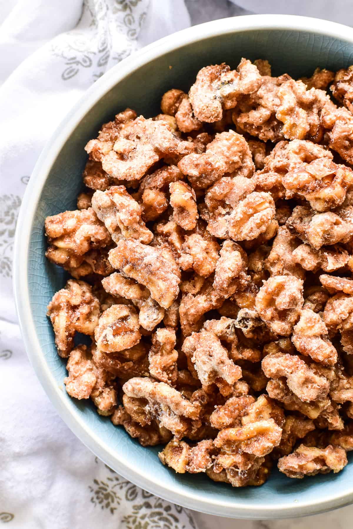 Overhead shot of Candied Walnuts in a blue bowl