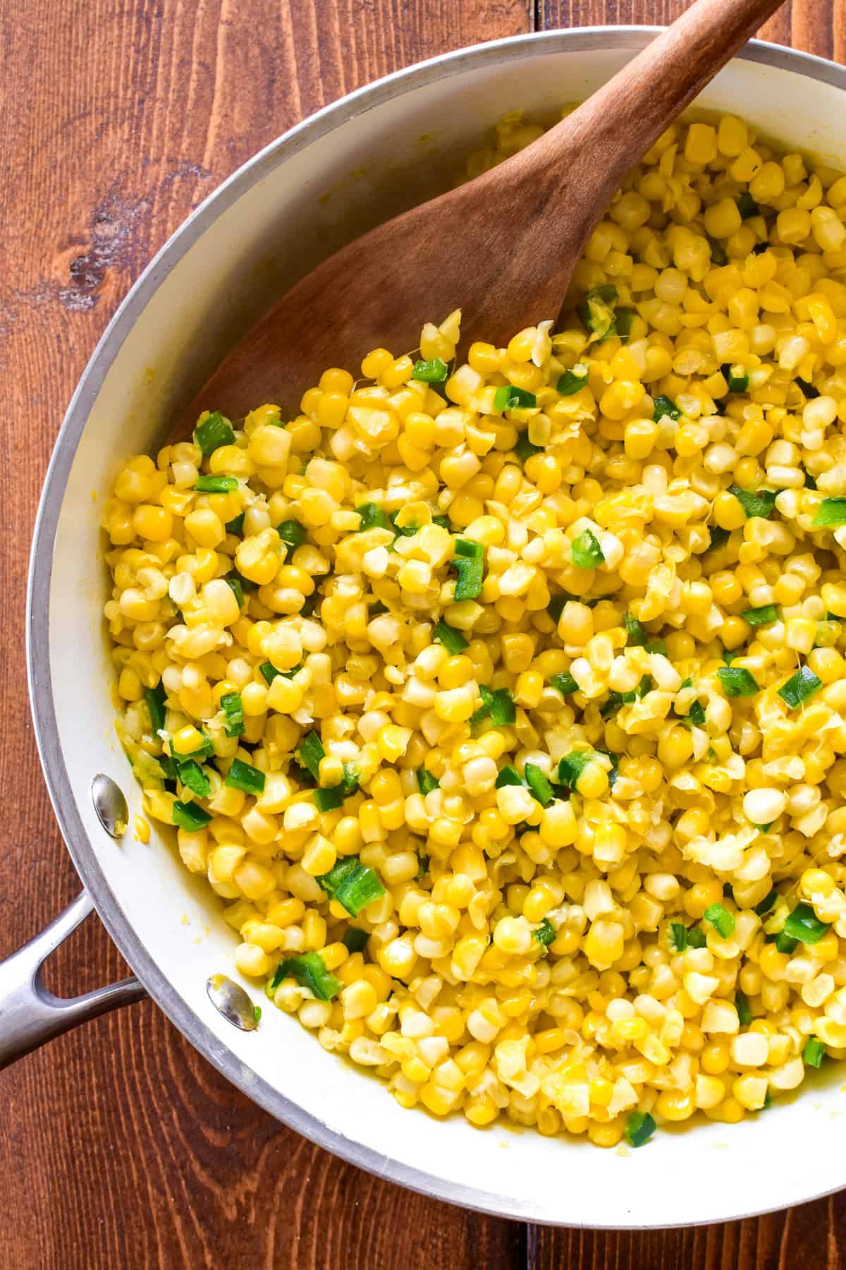 Corn and diced poblanos in a skillet