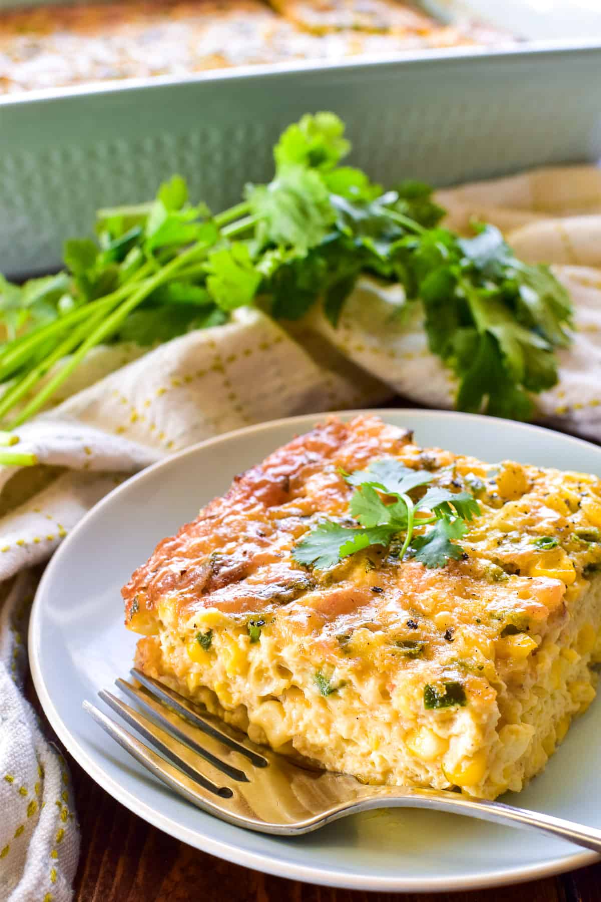 Piece of Corn Pudding on a small dish with a fork