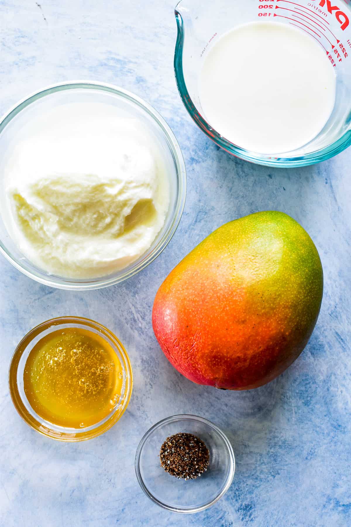 Mango Lassi ingredients on a blue background