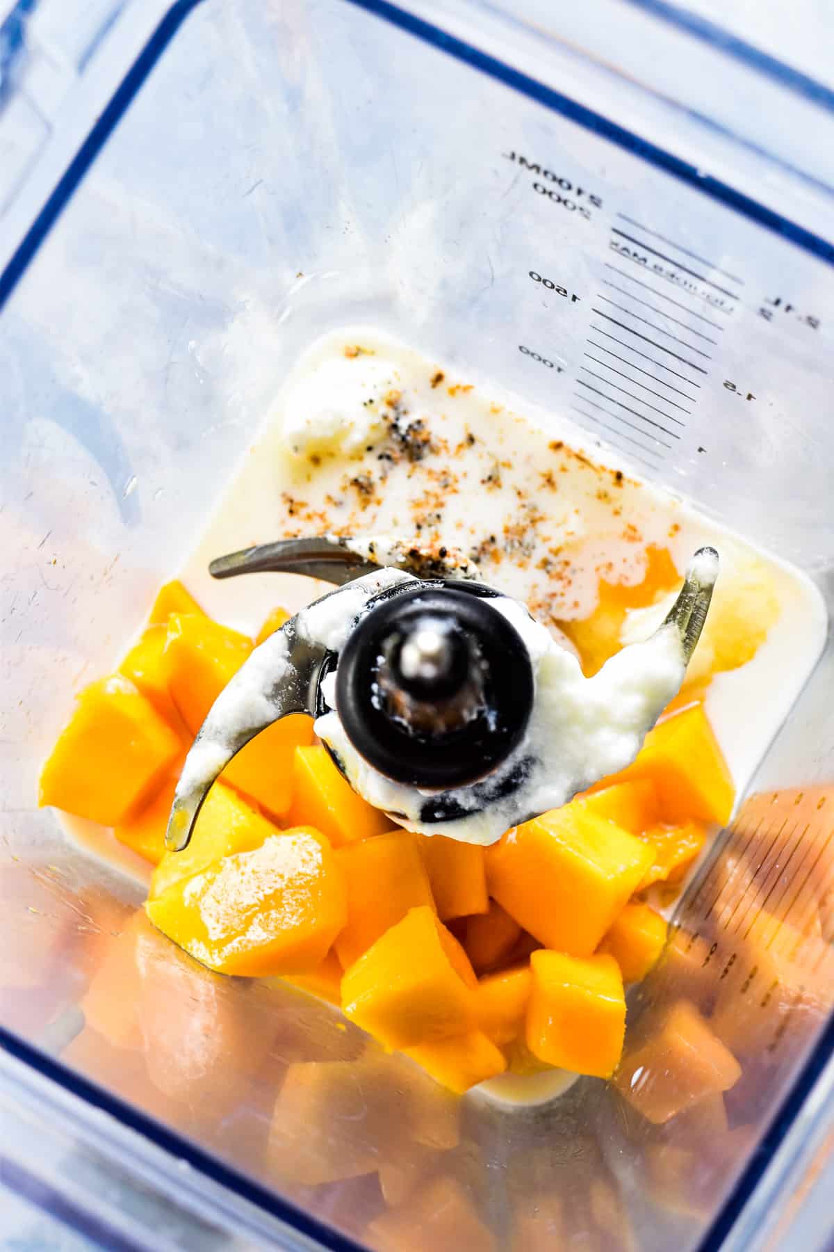 Overhead shot of Mango Lassi ingredients in a blender