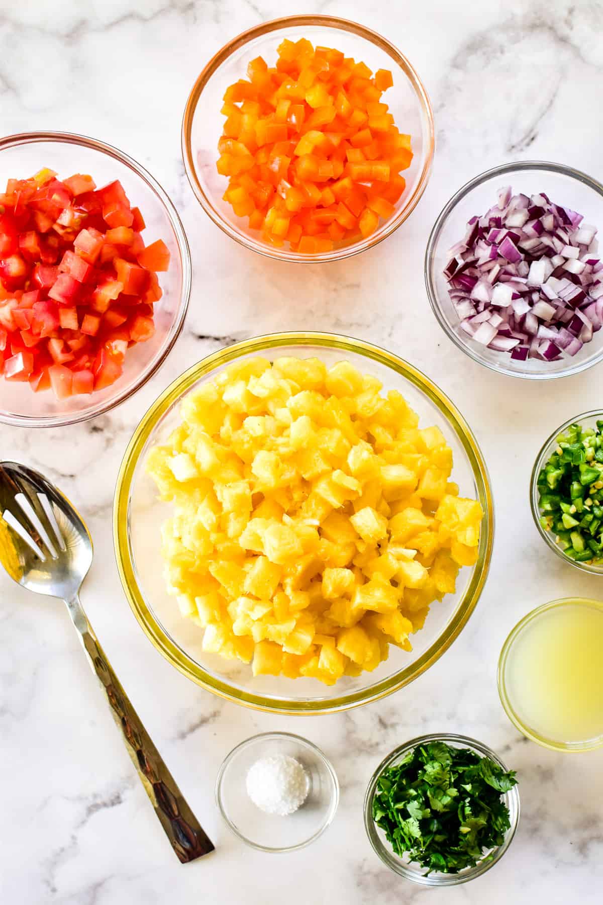 Pineapple Salsa ingredients chopped in glass bowls