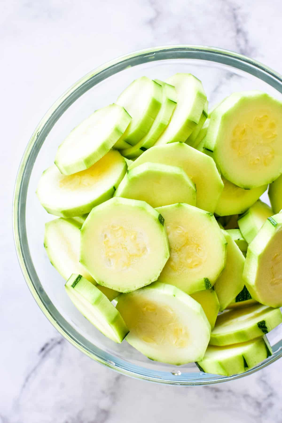 Sliced zucchini in a glass bowl