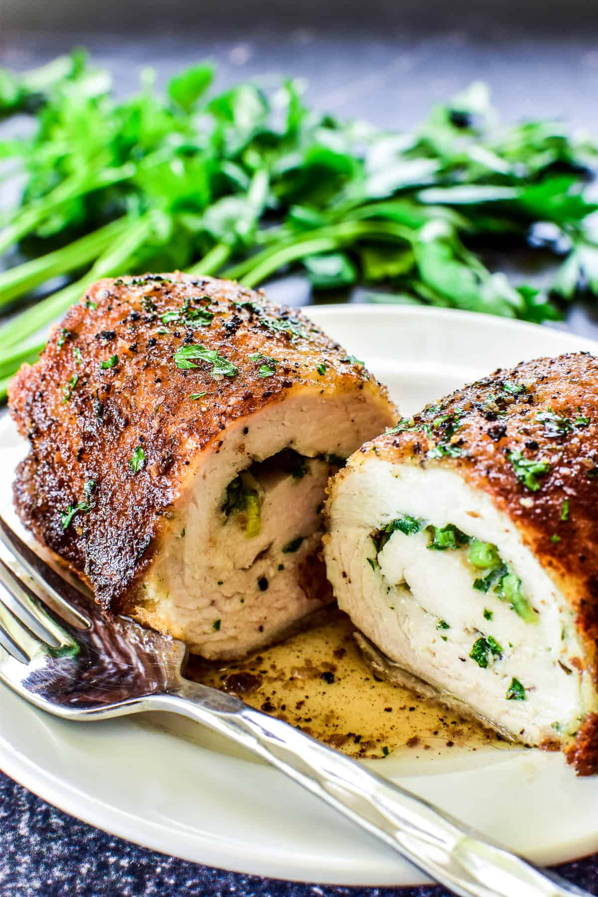 Close up of Chicken Kiev cut in half on a white plate