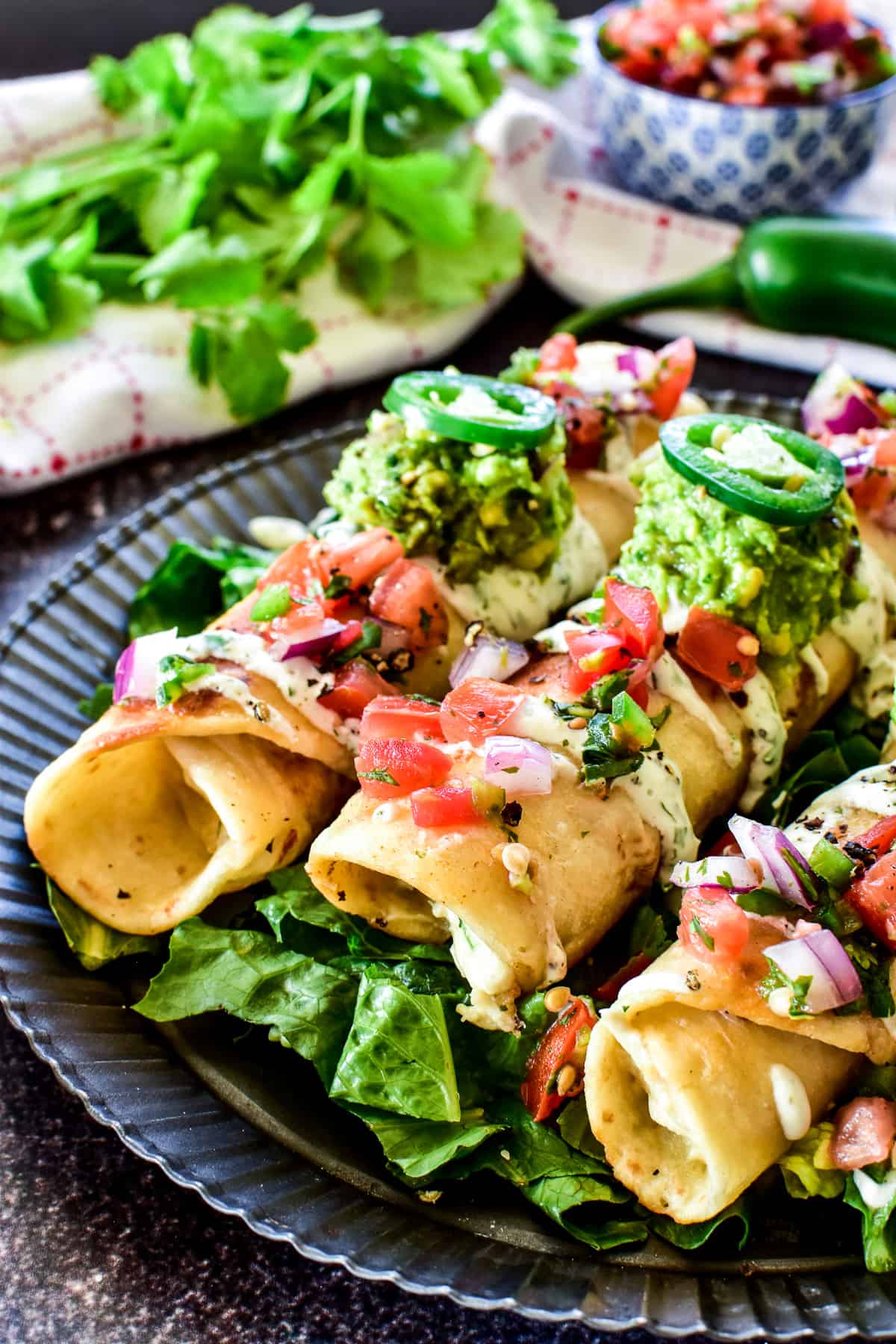 Close up of Creamy Chicken Flautas on metal serving tray