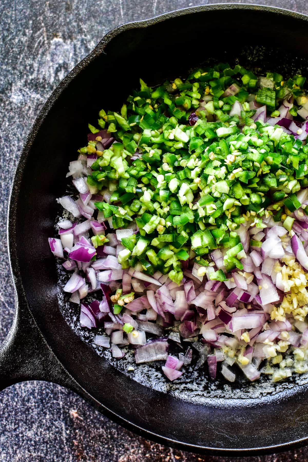 Red onion, garlic, and jalapeno in a cast iron skillet