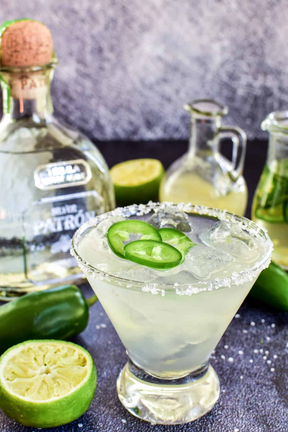 Jalapeño Margarita with limes, jalapeños, and a bottle of Patron