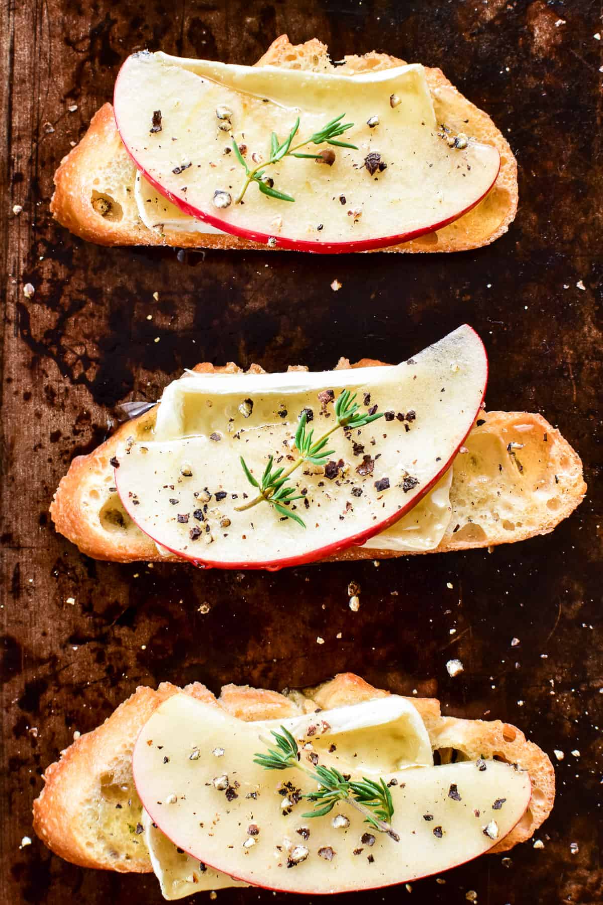 Overhead close up of 3 crostini on baking sheet