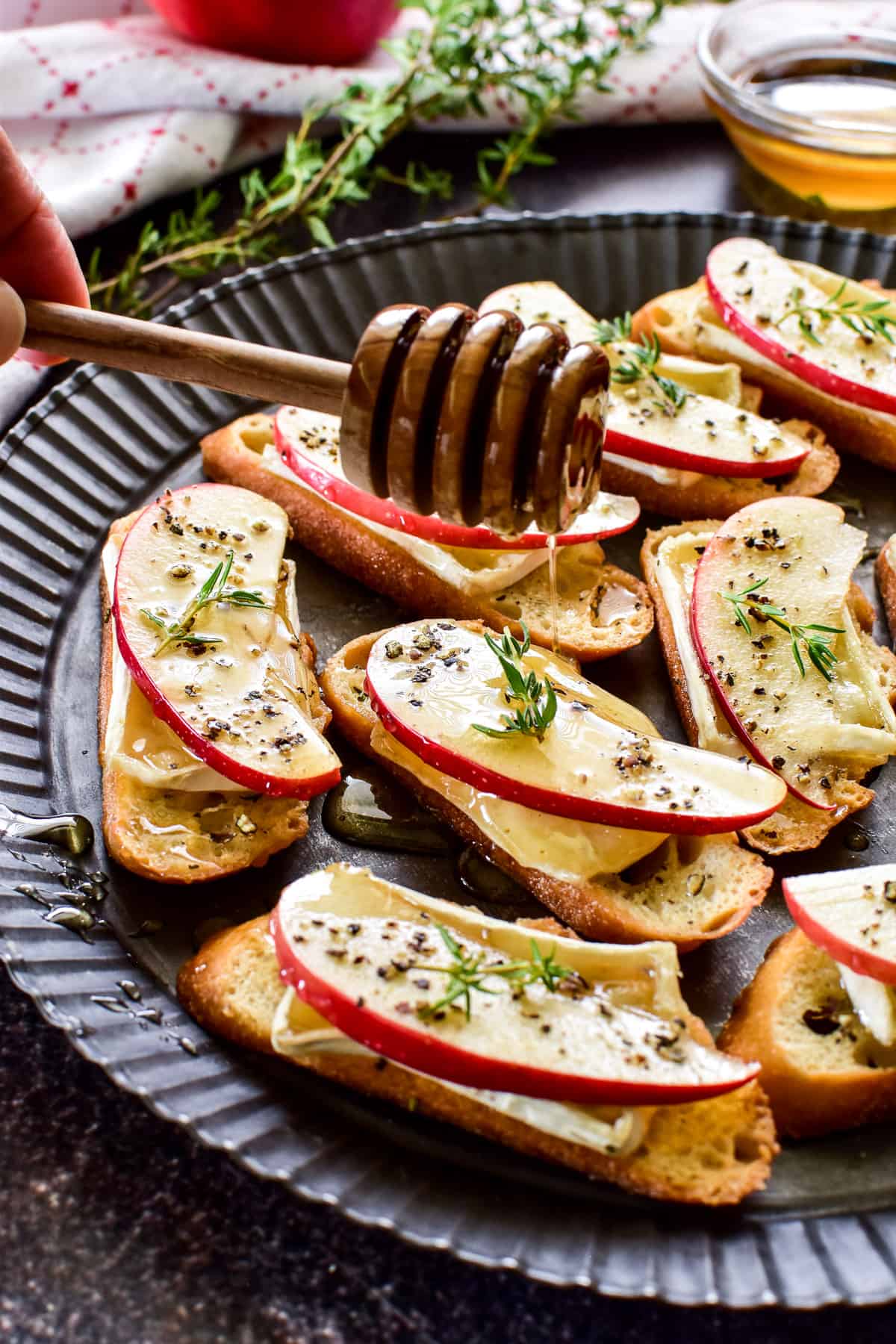 Honey drizzling onto Apple Brie Crostini