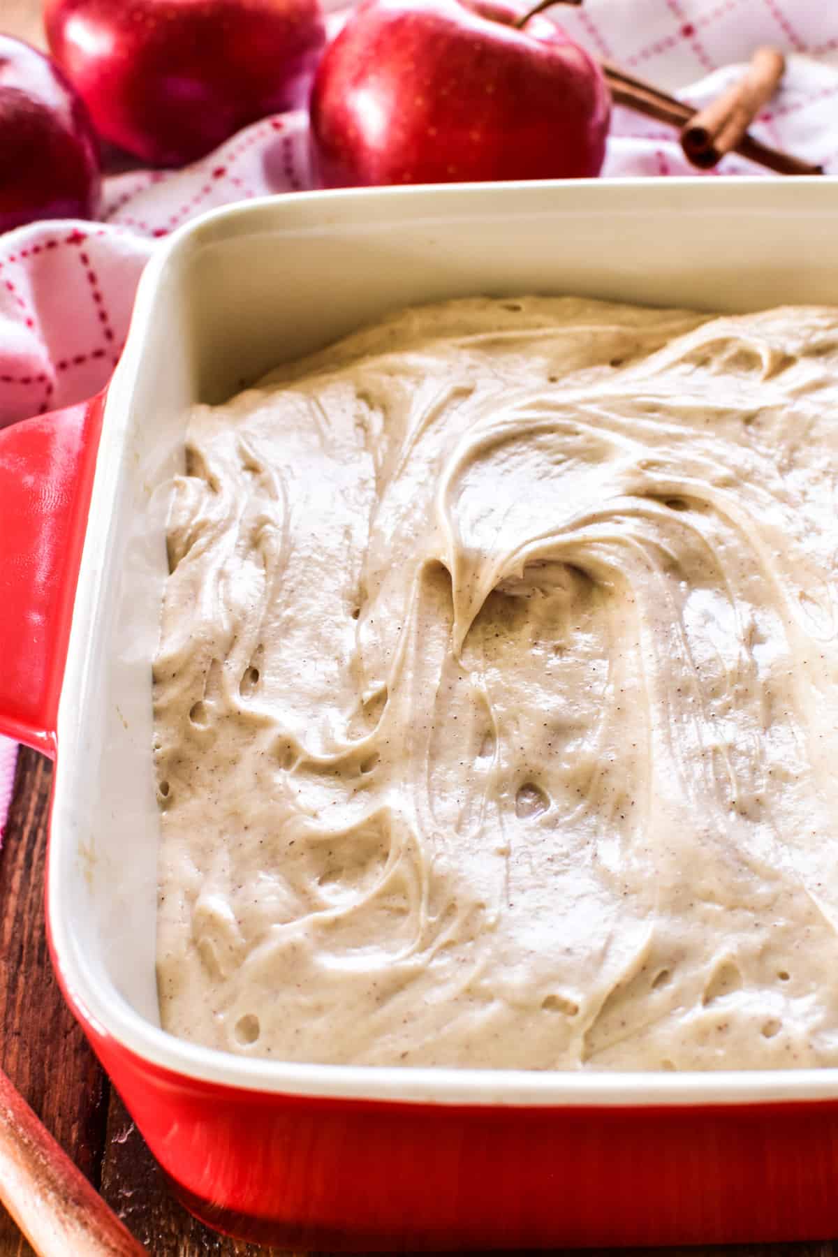 Side view of apple cake with cinnamon cream cheese frosting