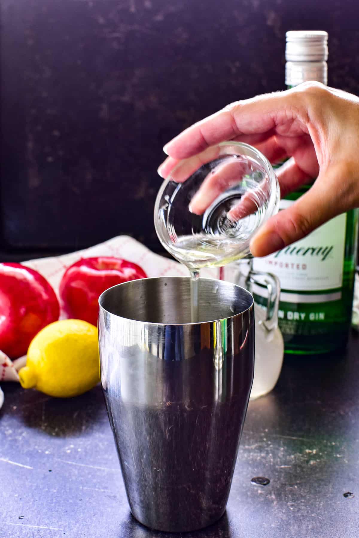 Adding the optional egg white to an Apple Gin Fizz