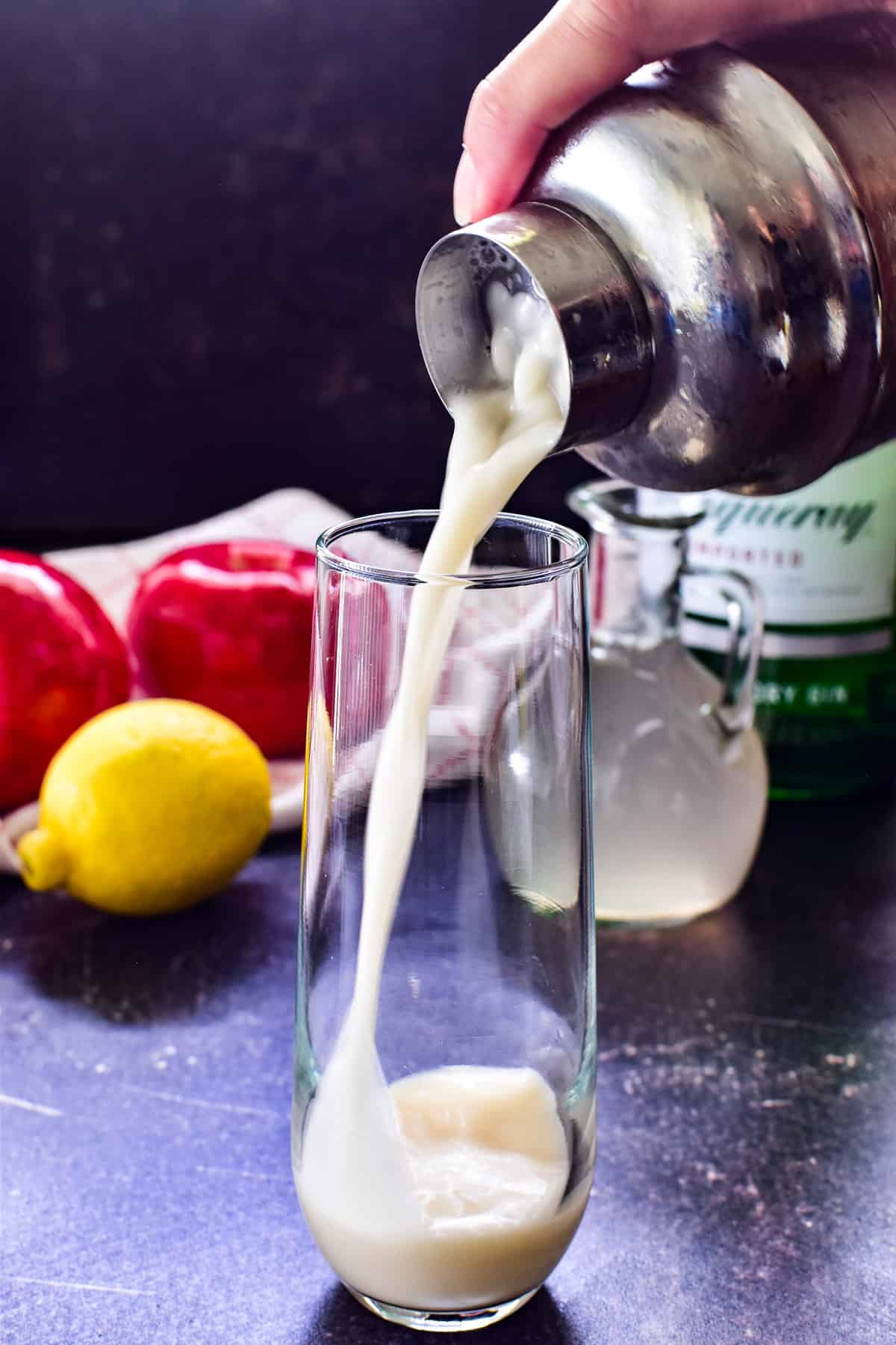 Pouring an Apple Gin Fizz into a glass