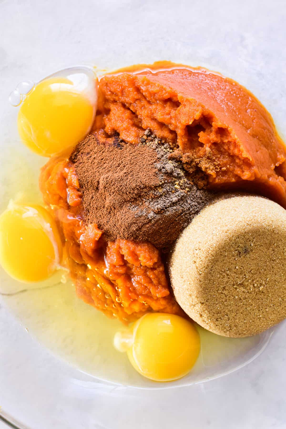 Pumpkin cheesecake ingredients in a mixing bowl