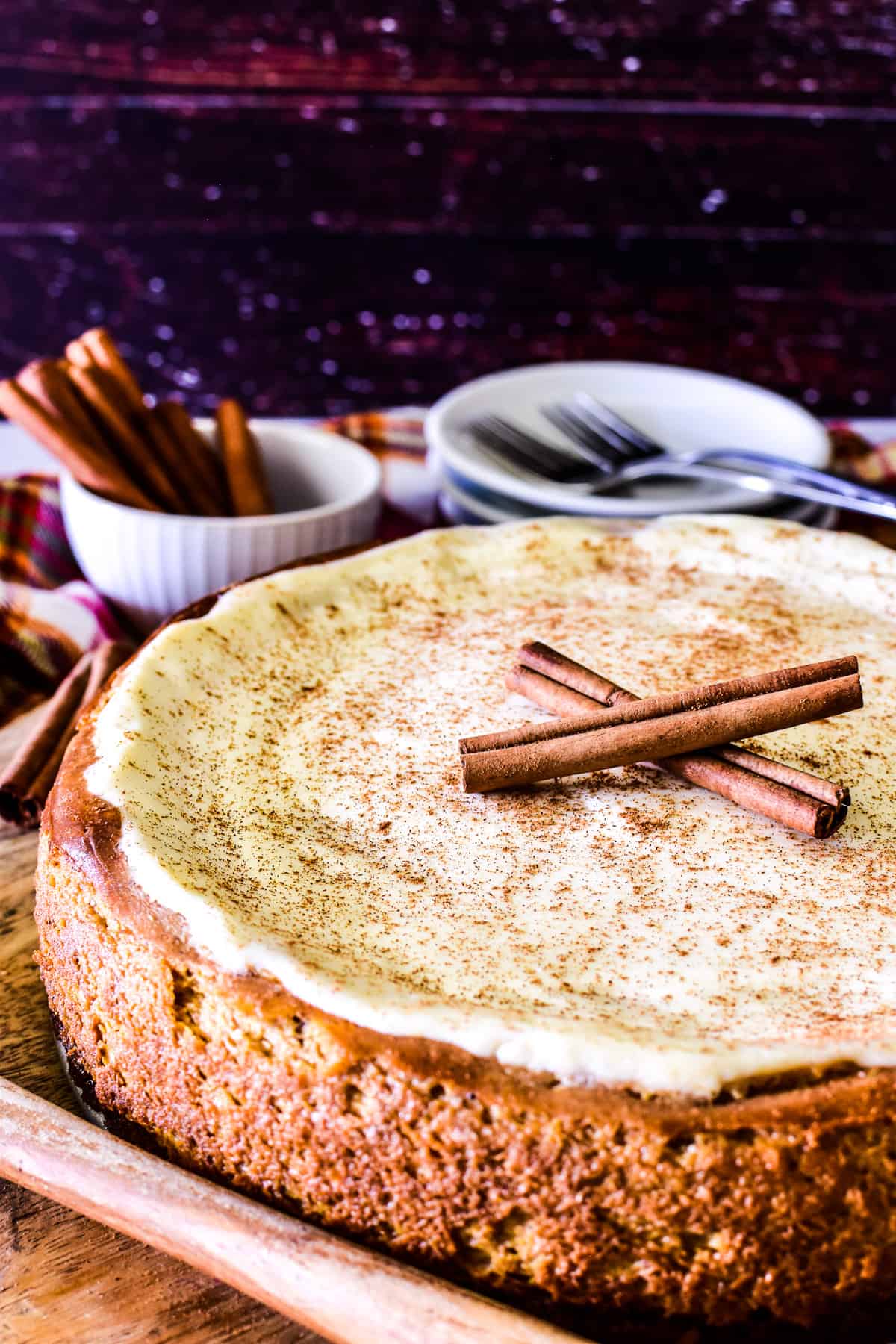 Whole Pumpkin Cheesecake with sour cream topping and cinnamon