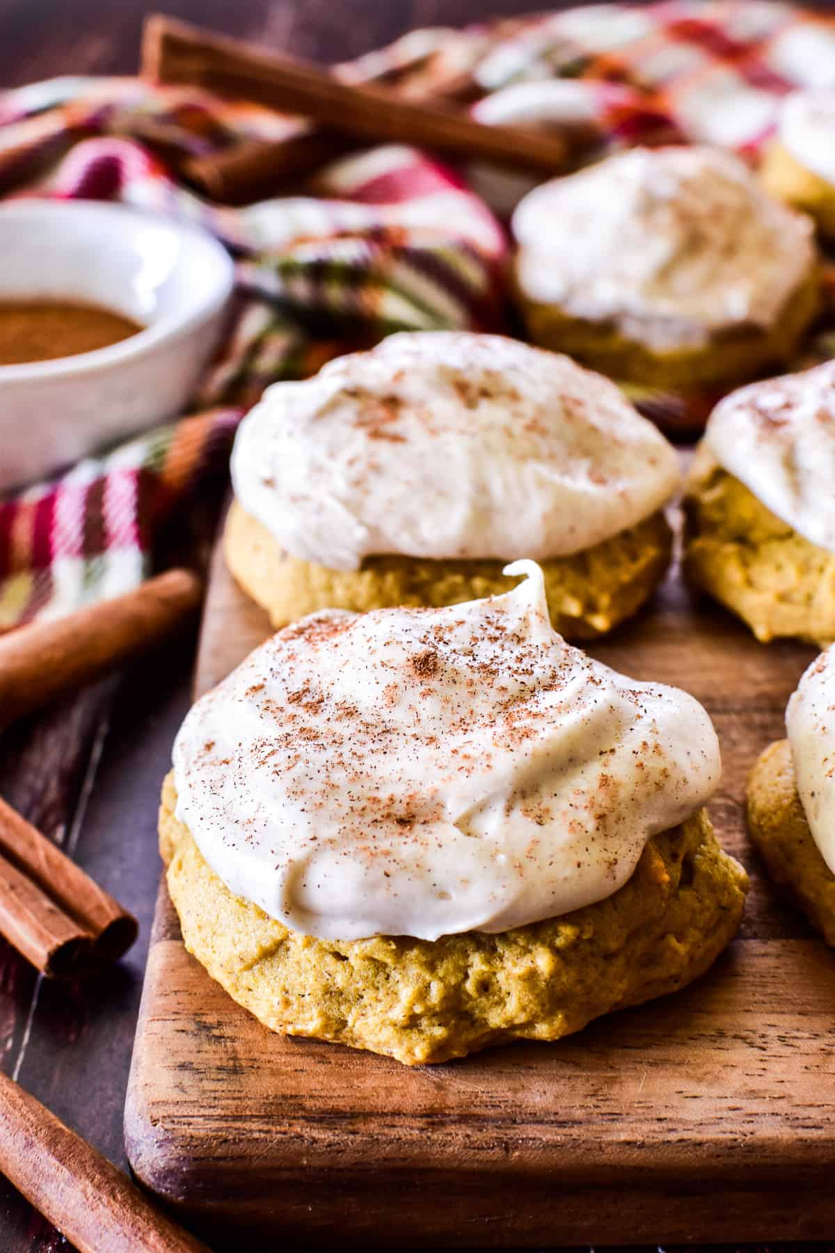 Close up of Frosted Pumpkin Cookie with a sprinkle of cinnamon