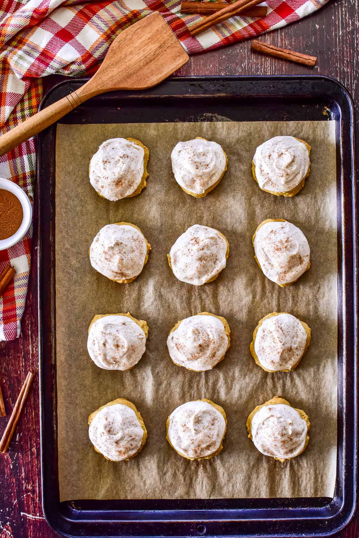Overhead photo of frosted Pumpkin Cookies on baking sheet