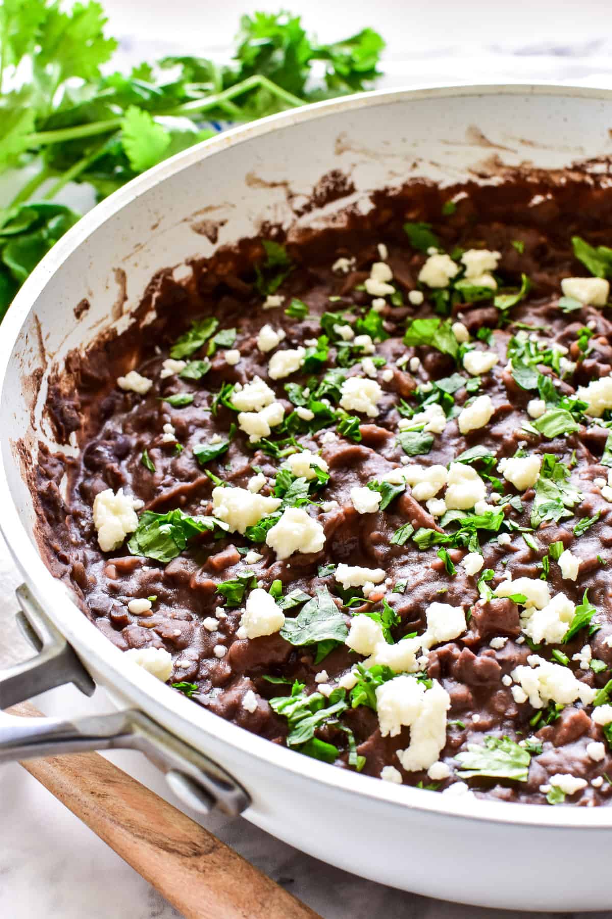 Refried Black Beans garninshed with queso fresco and cilantro