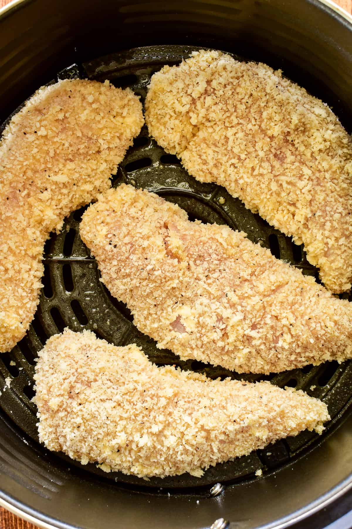 Chicken Tenders in the air fryer basket ready to be air fried