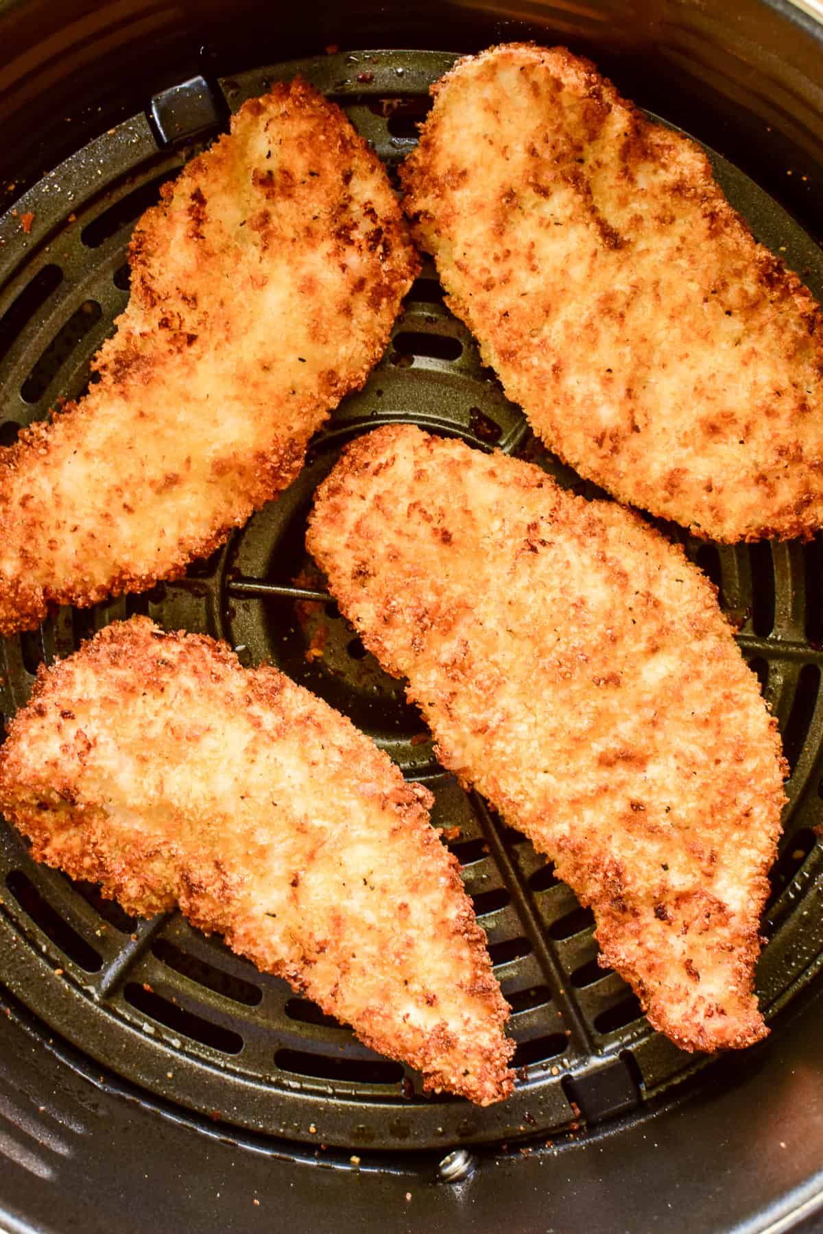 Chicken Tenders in the air fryer basket after air frying