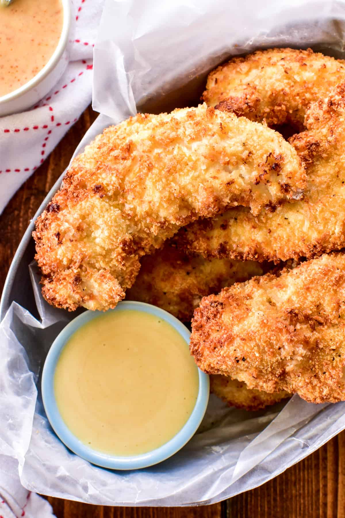 Overhead photo of Air Fryer Chicken Tendersin a basket with honey mustard