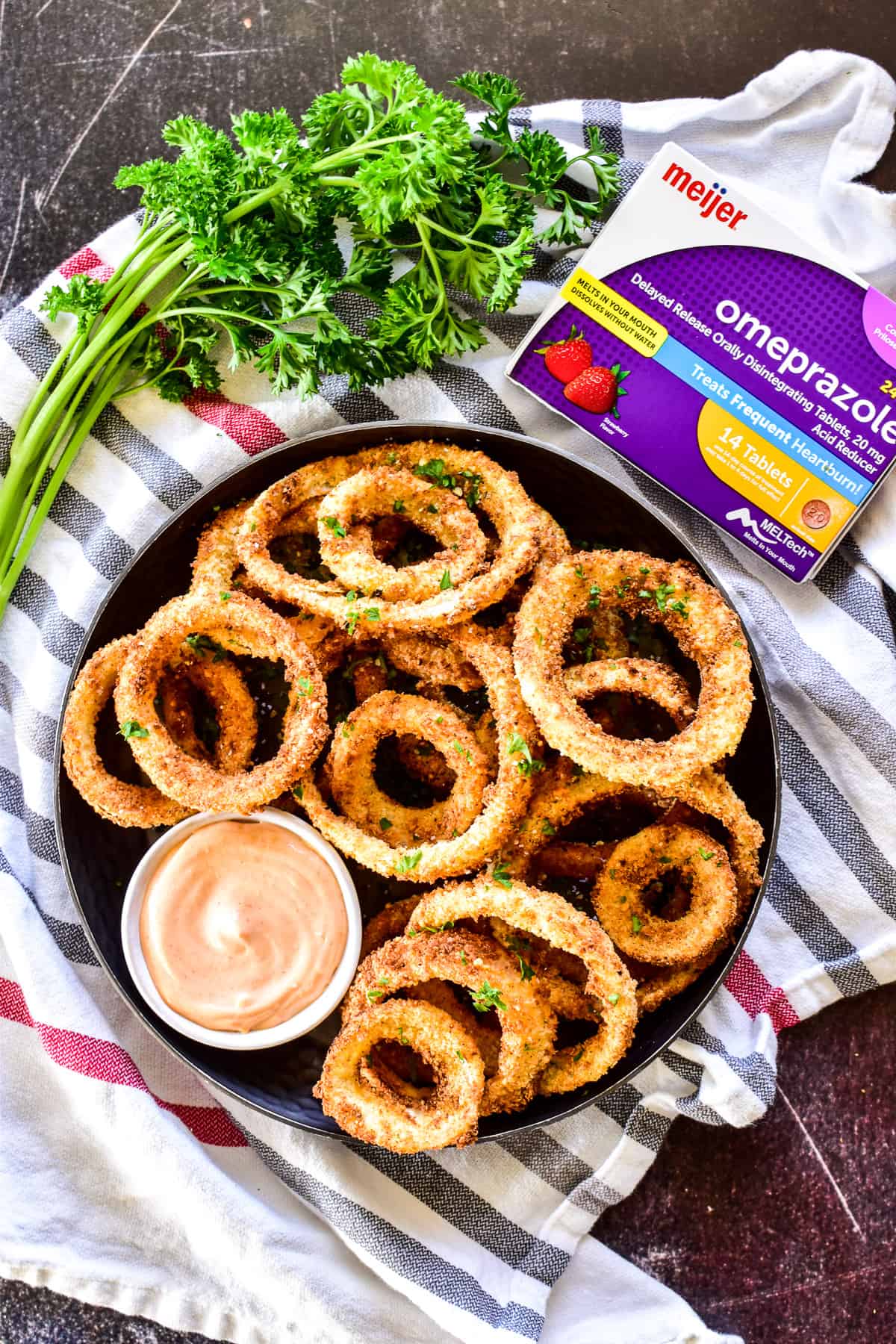 Overhead shot of Air Fryer Onion Rings with sauce and heartburn medication