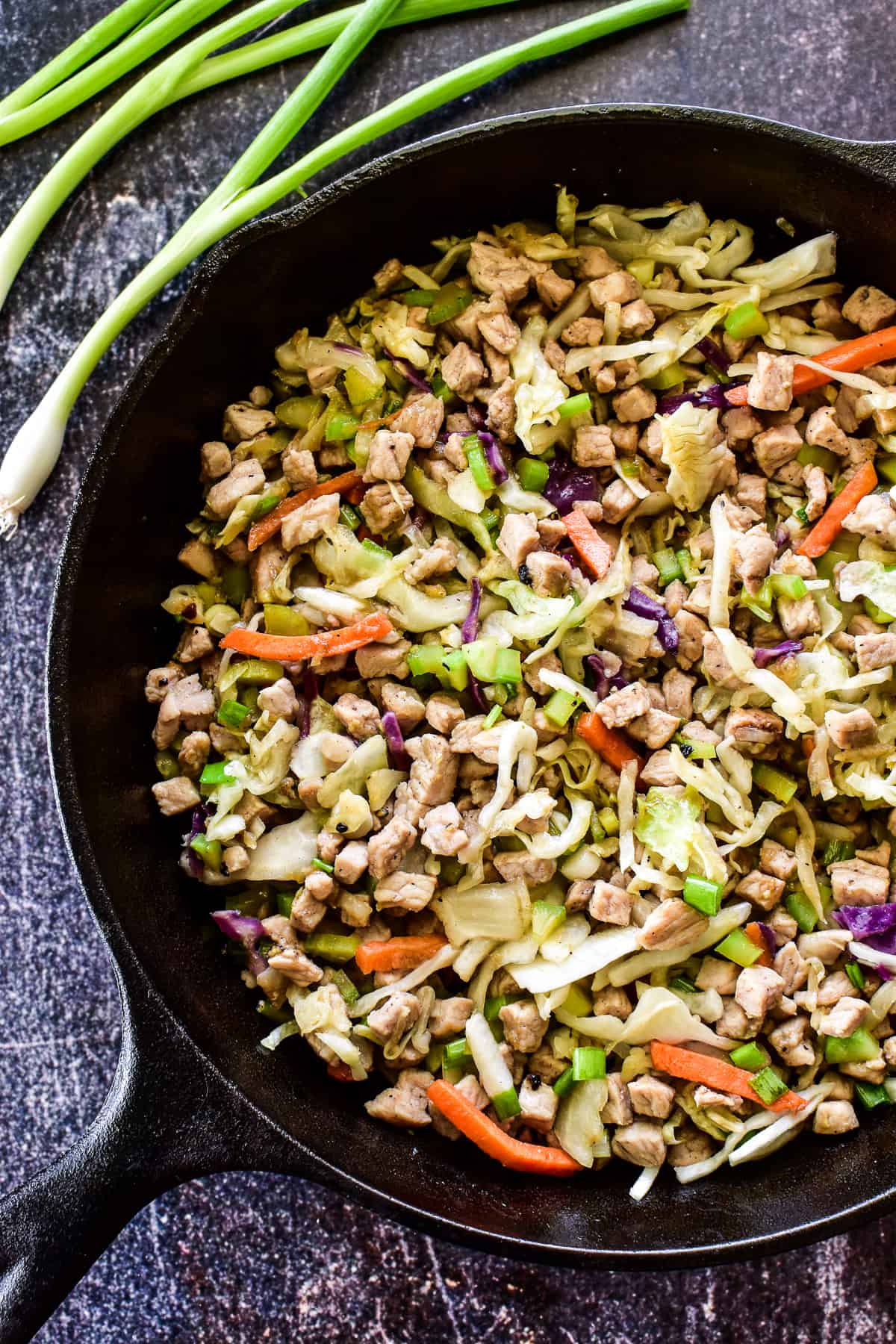 Pork egg roll filling in a cast iron skillet