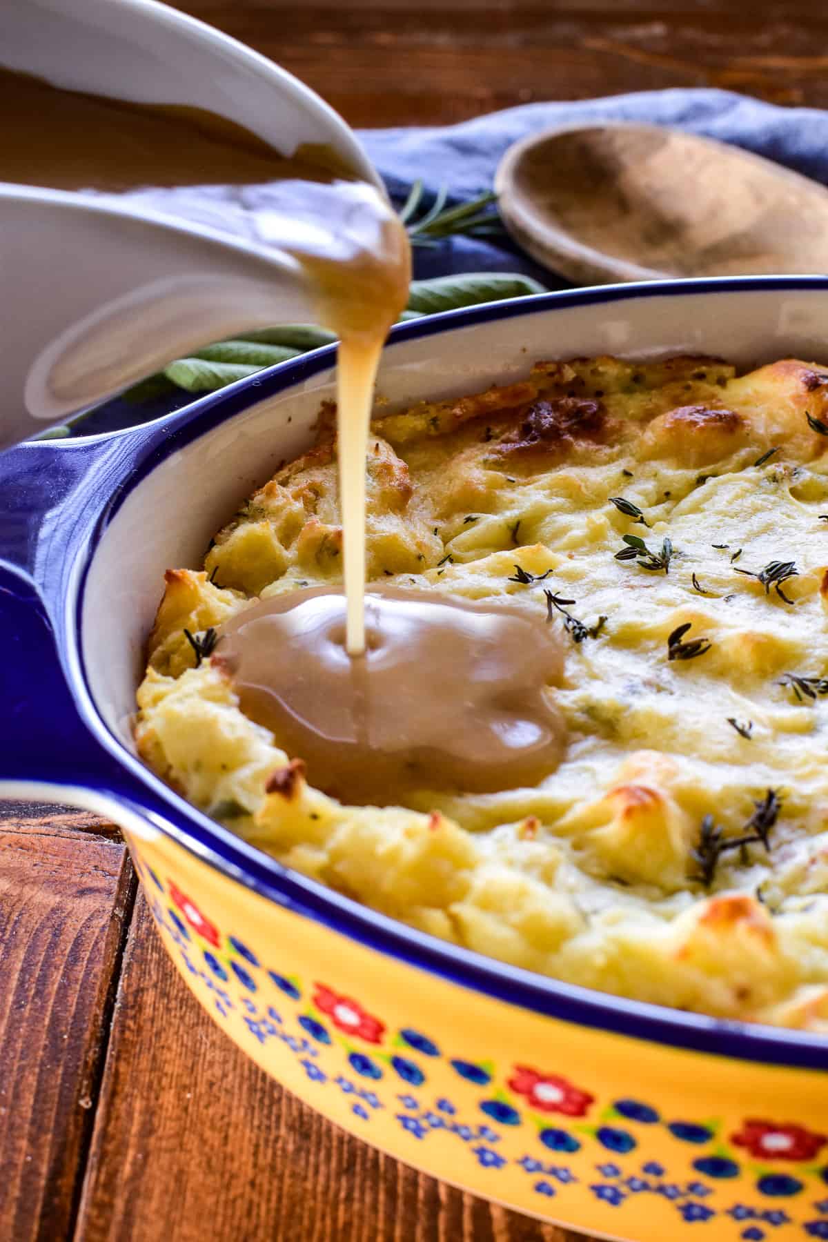 Pouring gravy on Twice Baked Mashed Potatoes