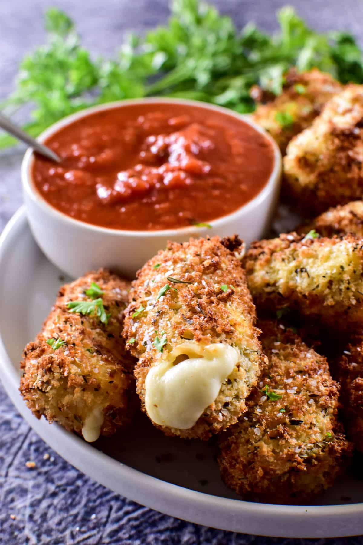 Close up of Air Fryer Mozzarella Sticks with marinara sauce