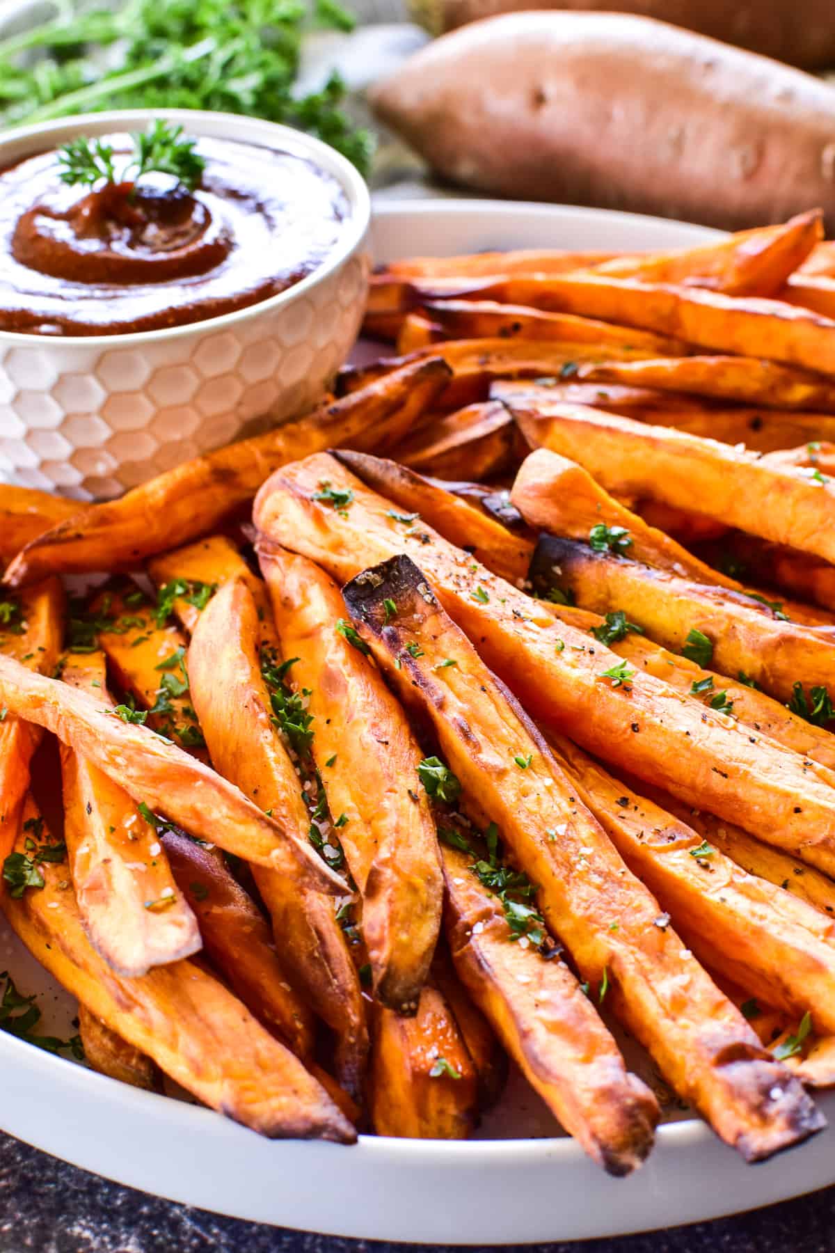 Side view of Sweet Potato Fries on a white plate