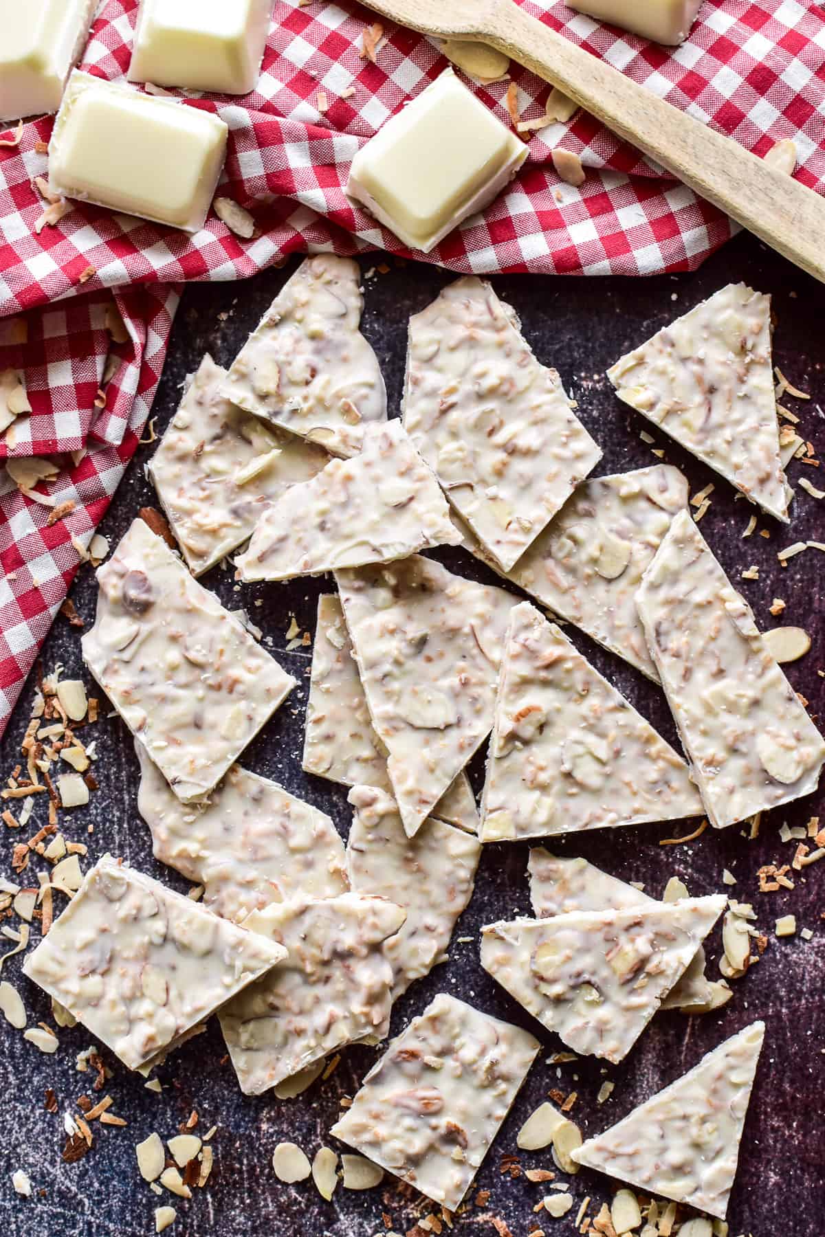 Overhead shot of Toasted Coconut Bark with a red & white checkered towel