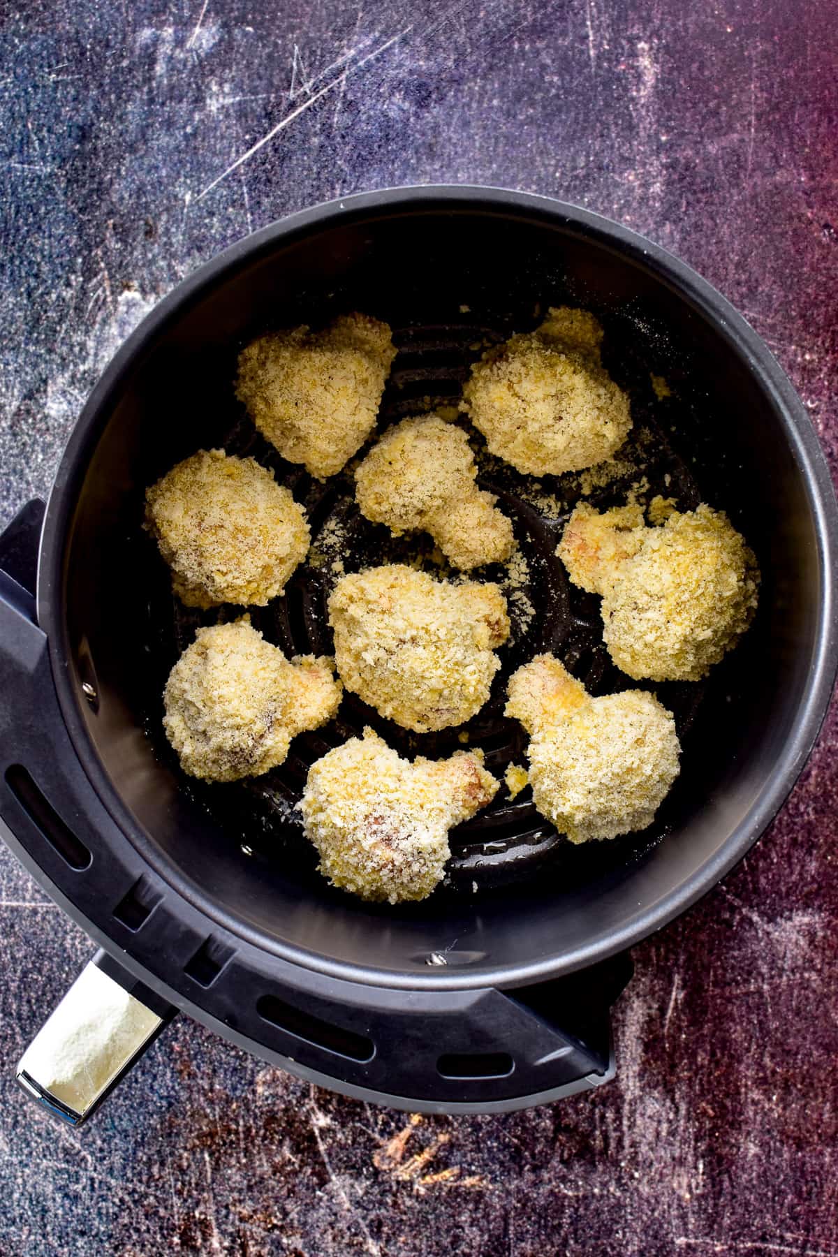 Breaded Mushrooms in an air fryer basket