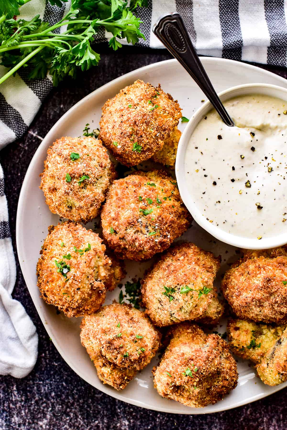 Overhead image of Air Fryer Mushrooms on a white plate with sauce