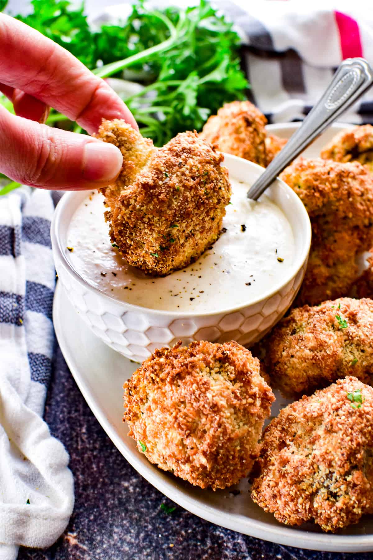 Air Fryer Mushroom being dipped in Horseradish Sauce