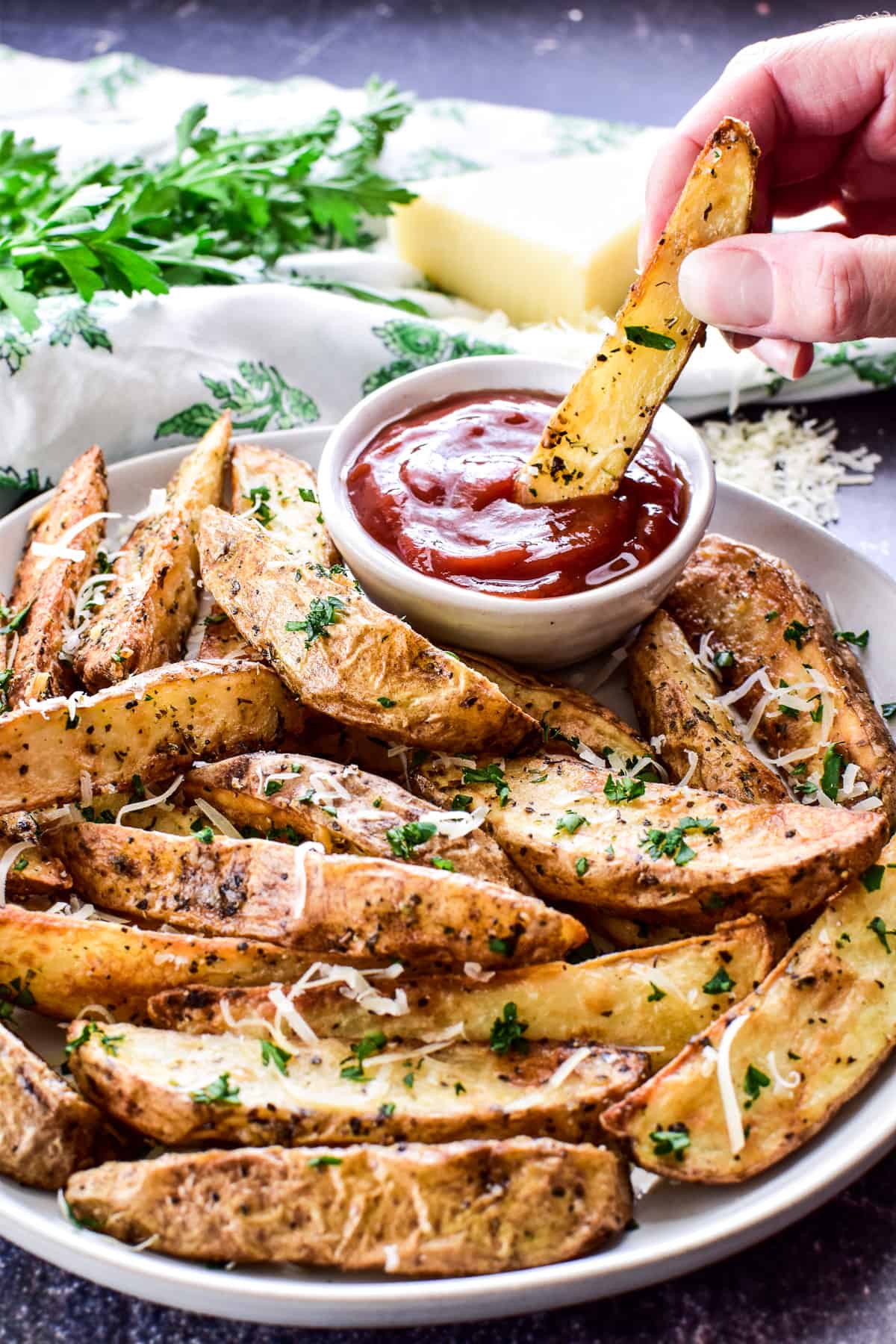 Air Fryer Potato Wedge being dipped into ketchup