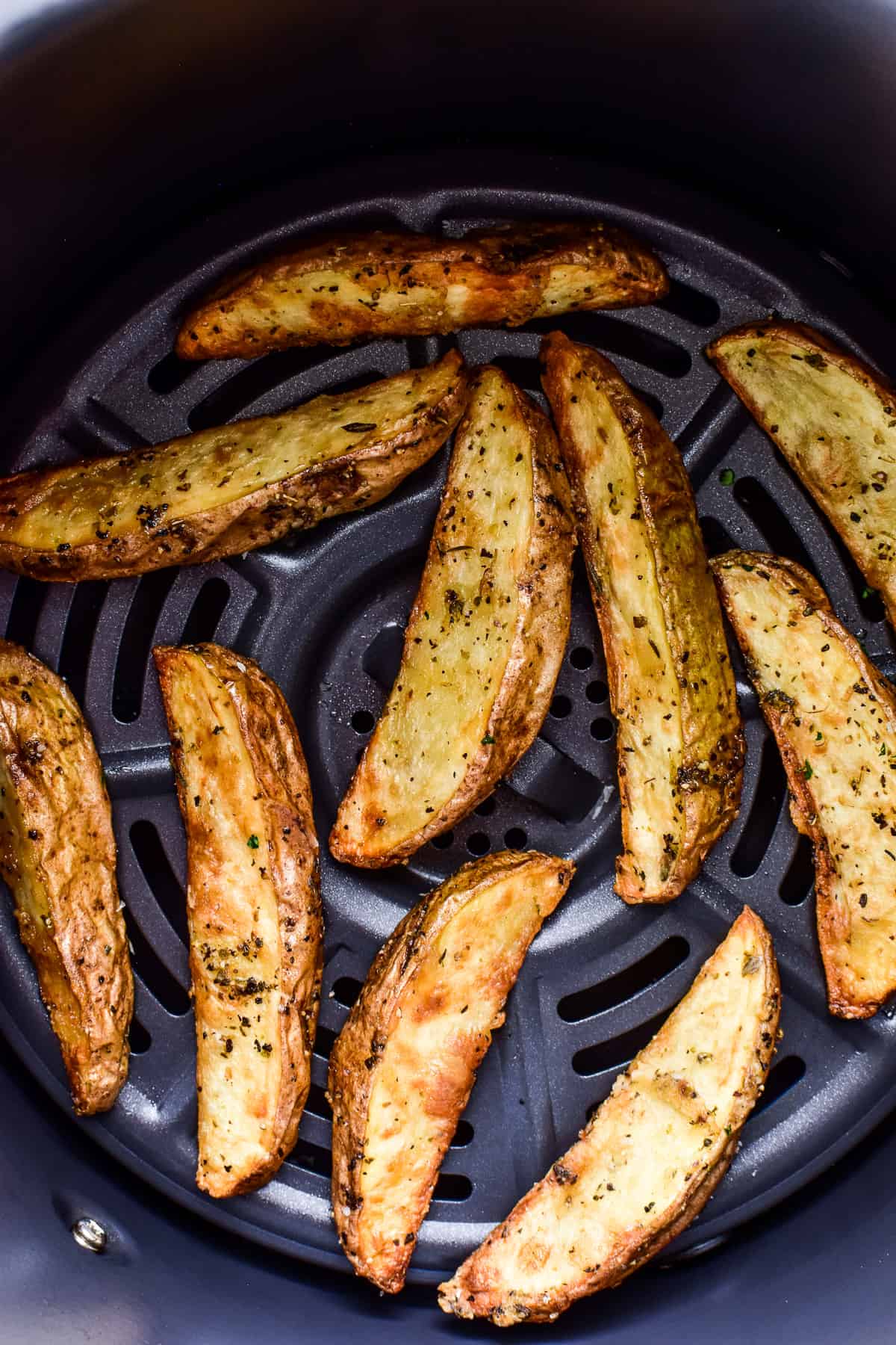 Potato Wedges in an air fryer basket