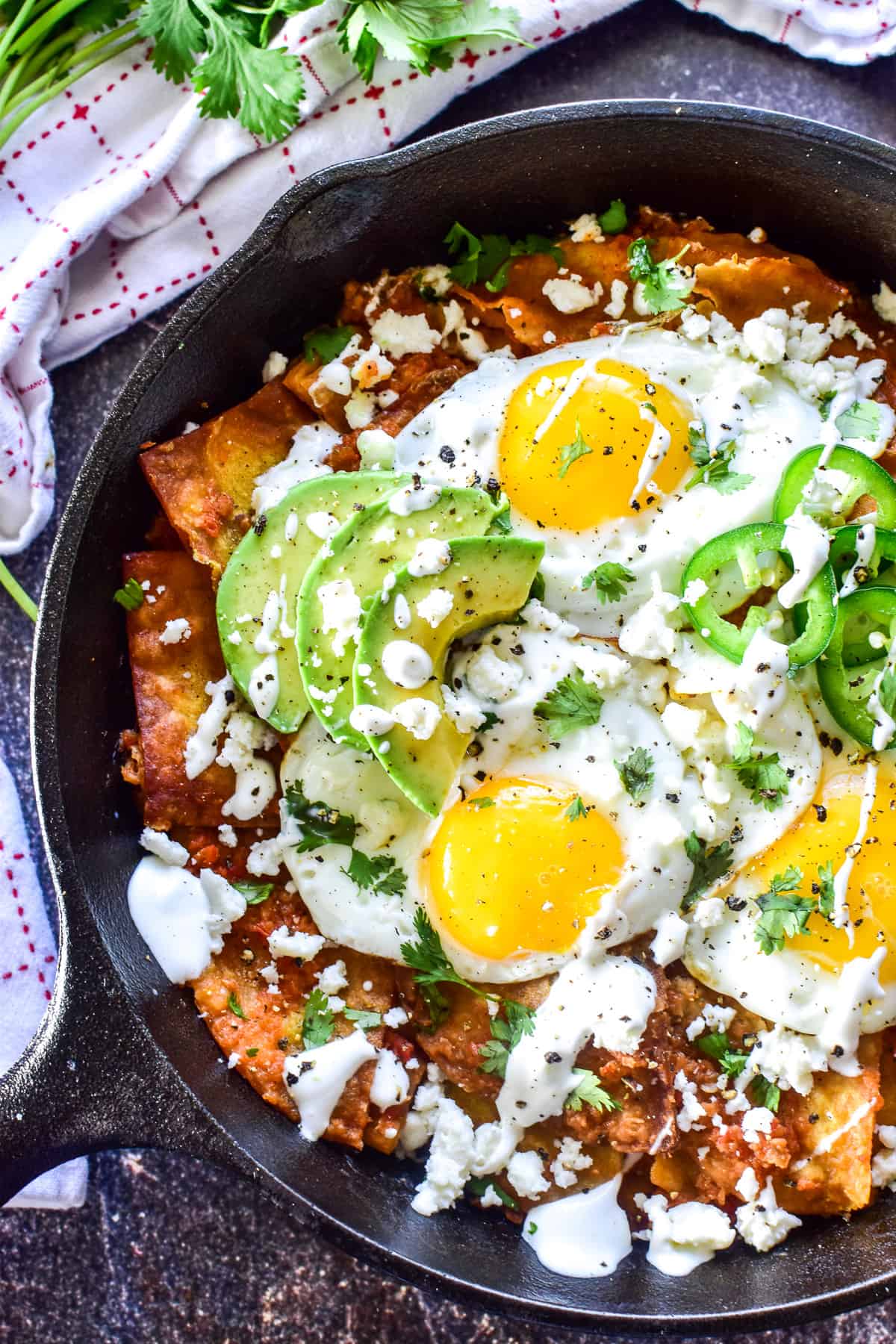 Overhead shot of chilaquiles in a cast iron skillet