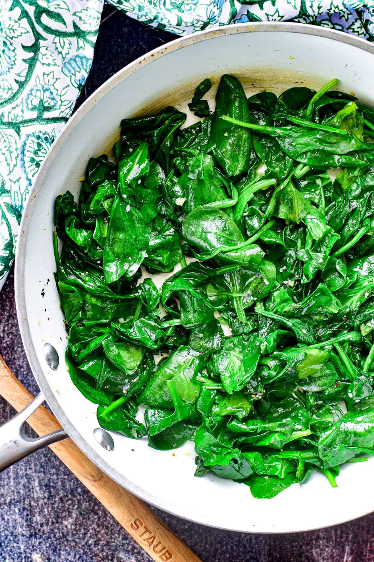 Overhead Shot of Sauteed Spinach in a white skillet