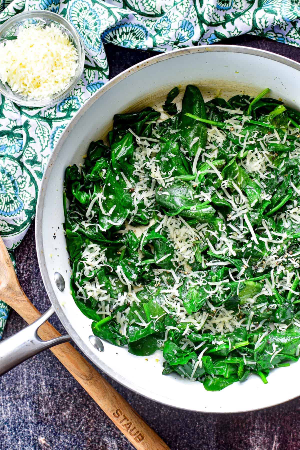 Overhead shot of Sauteed Spinach with freshly grated Parmesan cheese