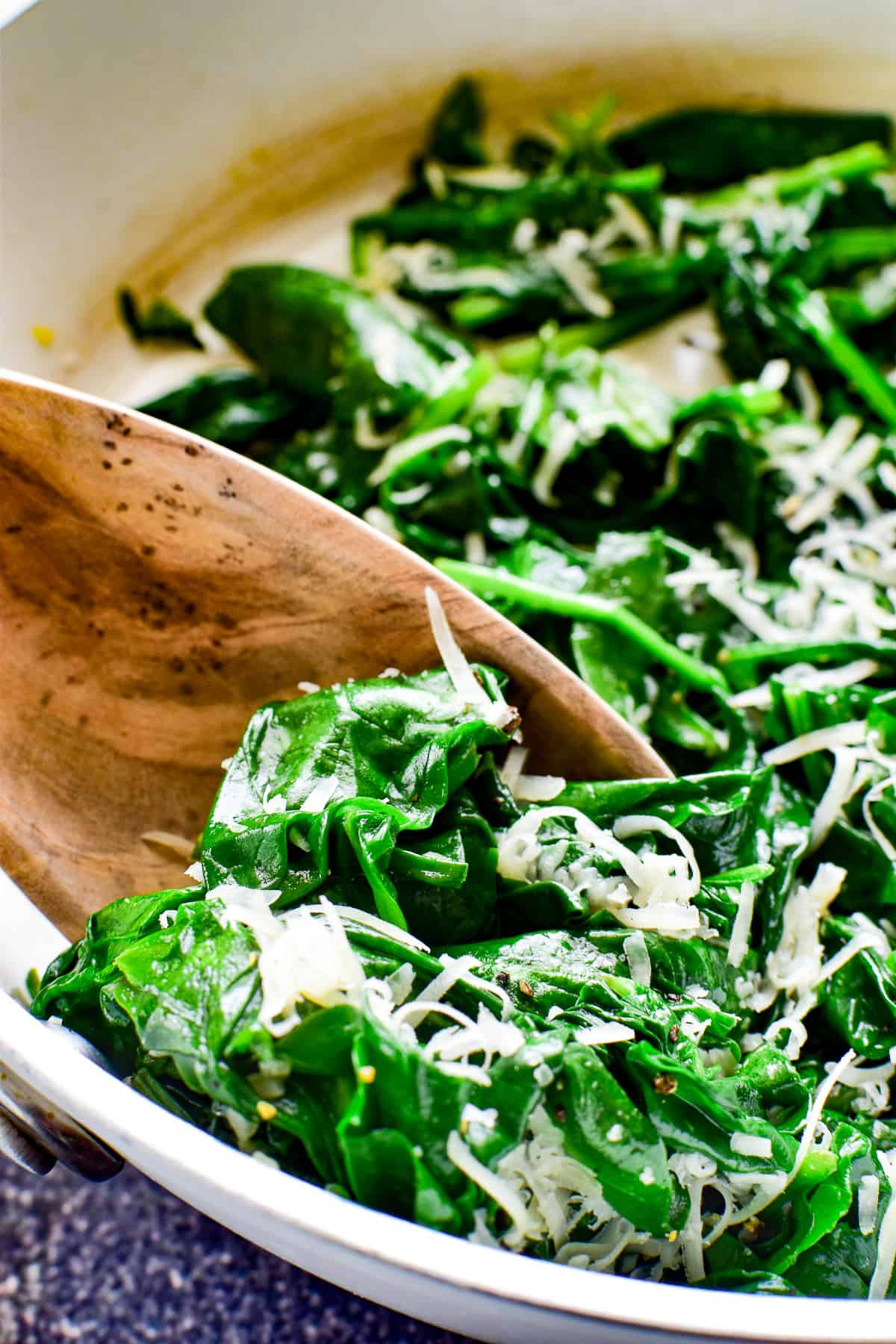 Close up of Sauteed Spinach on a wooden spoon