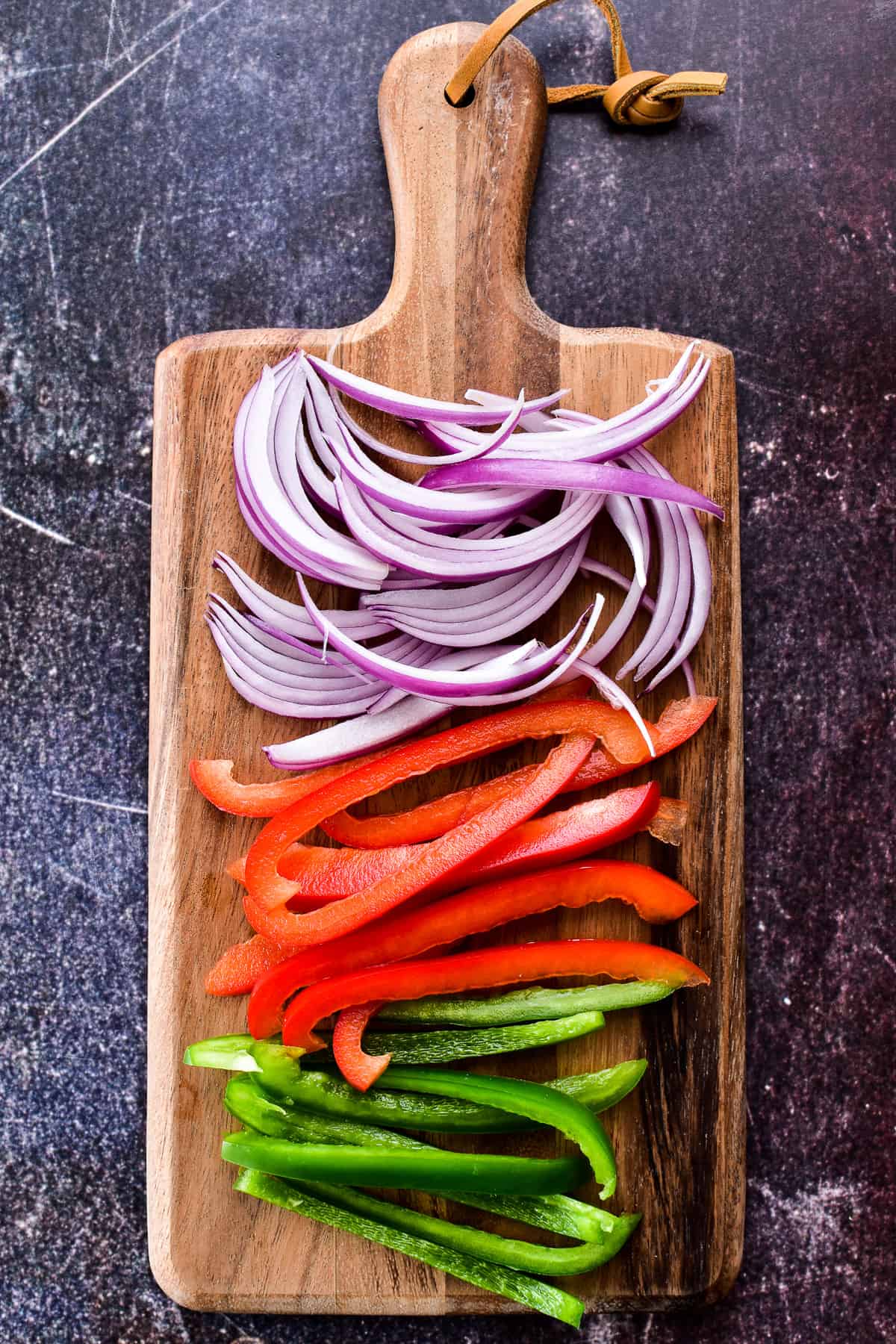 Thinly sliced red and green peppers and onions