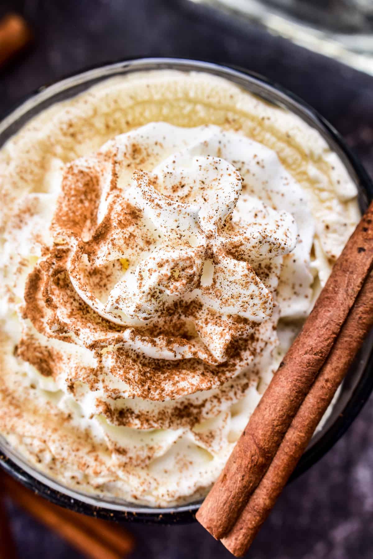 Overhead close-up of Mexican Coffee with whipped cream and cinnamon stick