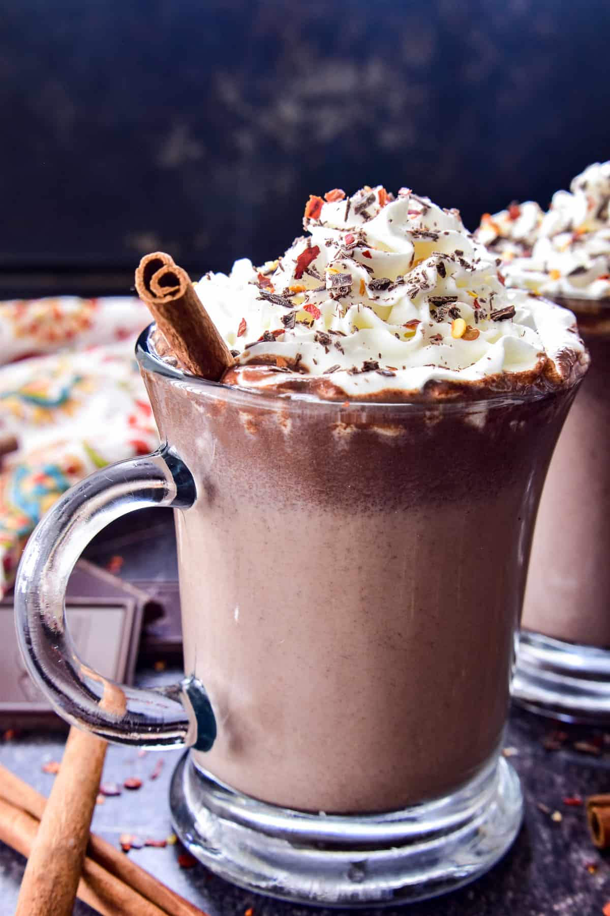 Mexican Hot Chocolate in a glass mug with whipped cream and garnishes